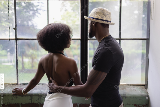 Young couple looking through window