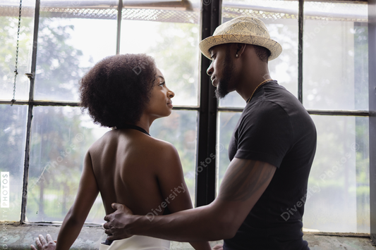Young couple standing by window