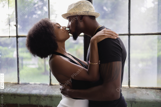 Young Black couple kissing, connected