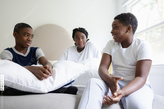 African American siblings talking at home