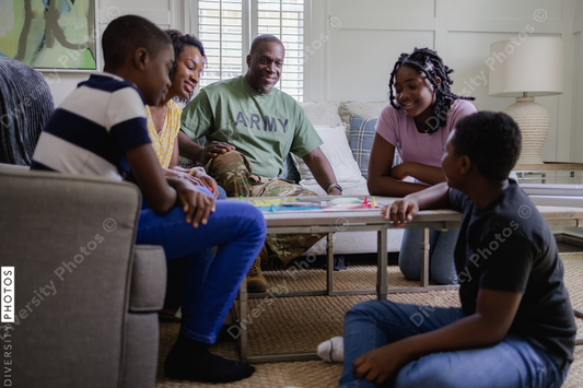 Black army family playing board games at home
