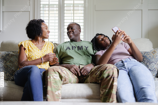 Black couple with preteen daughter on sofa
