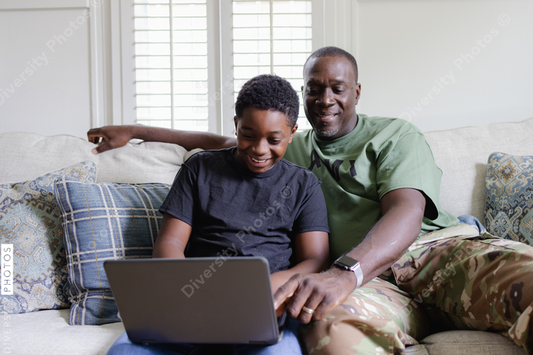 Black father helps son with homework, happiness