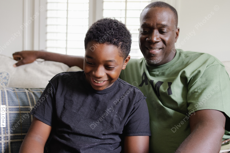 Black father helps son with homework, happiness
