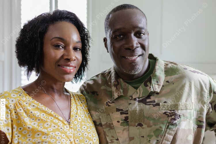 Feeling happy dad is home, family is complete, African American military, husband and wife, couple