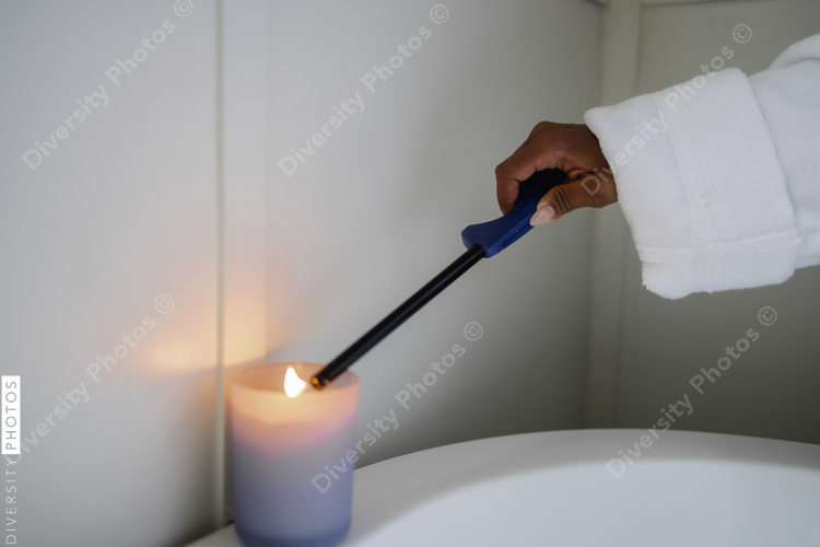 Hand of woman igniting bath candle