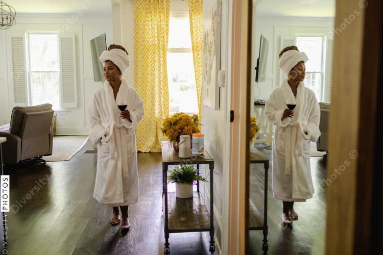 Woman in bathrobe walking around house