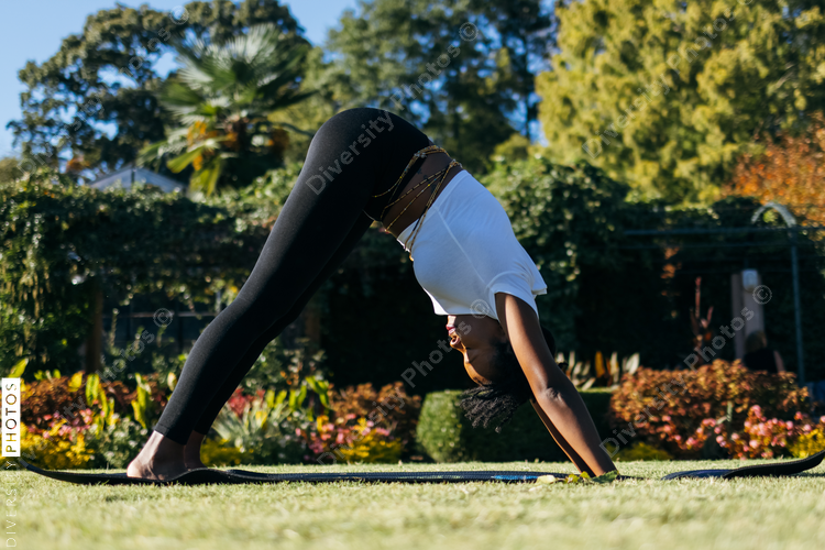Black woman doing yoga in the park