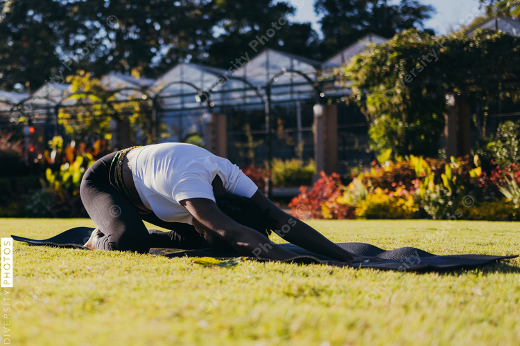 Black woman doing yoga in the park