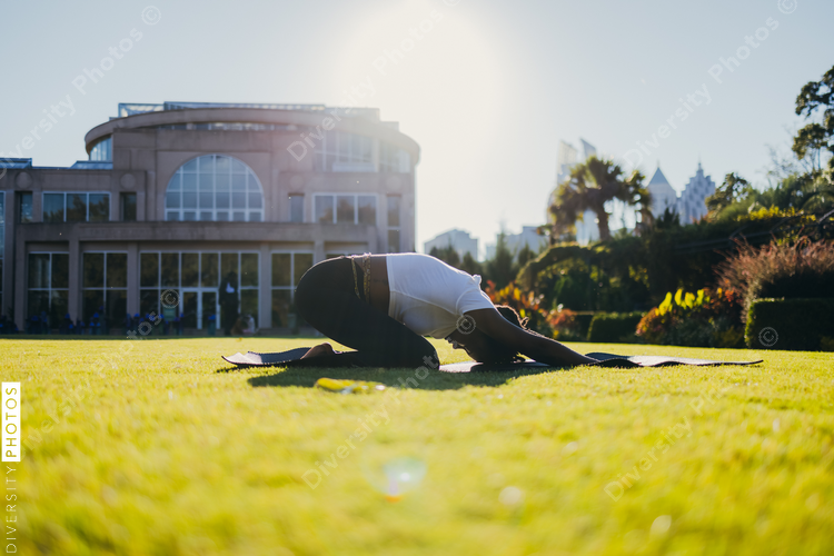Black woman doing yoga in the park