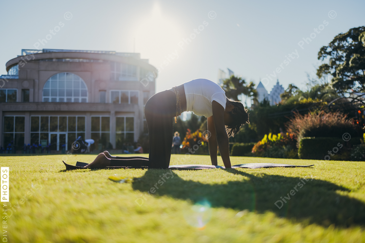 African American woman does yoga in the park