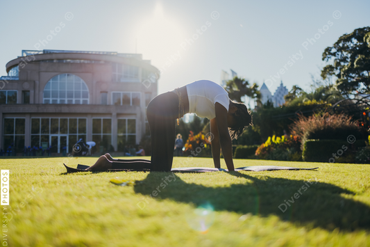 African American woman does yoga in the park