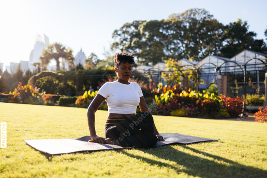 African American woman does yoga in the park