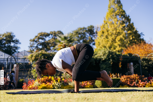 African American woman does yoga in the park