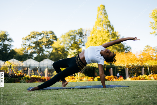 African American woman does yoga in the park
