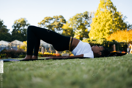 African American woman does yoga in the park
