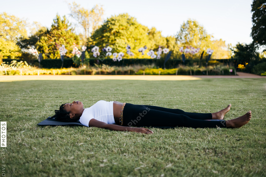African American woman does yoga in the park