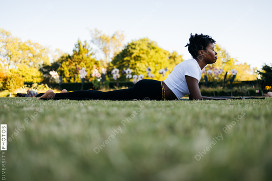 African American woman does yoga in the park
