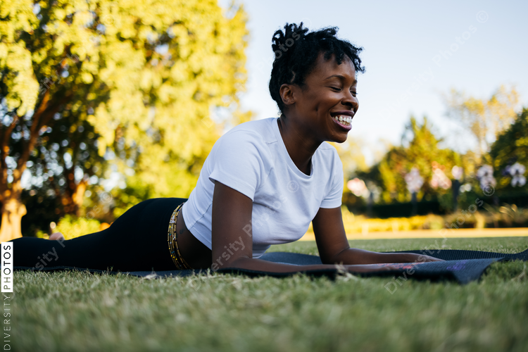 African American woman does yoga in the park
