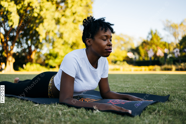 African American woman does yoga in the park