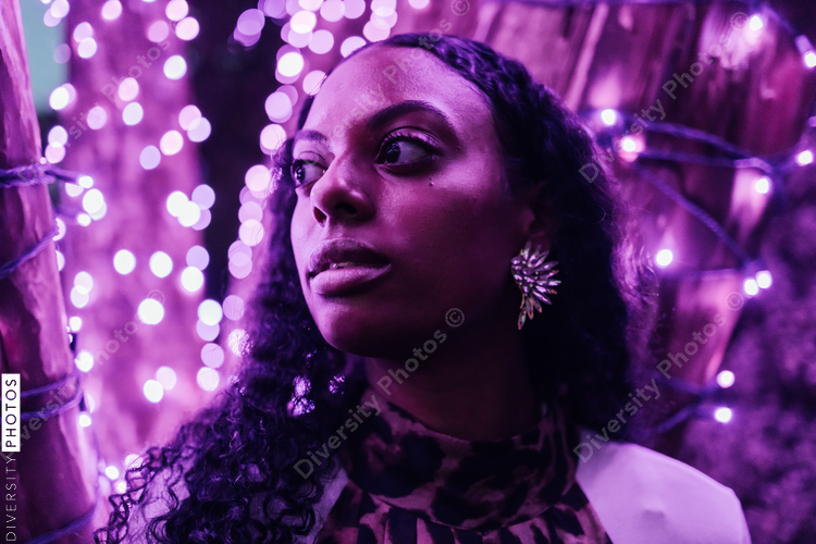 Portrait of a Black woman with neon purple lights