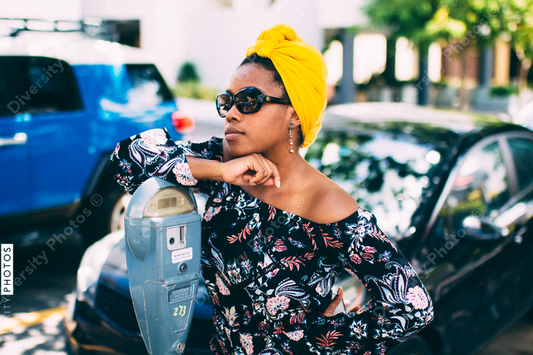 Young woman leaning on parking meter