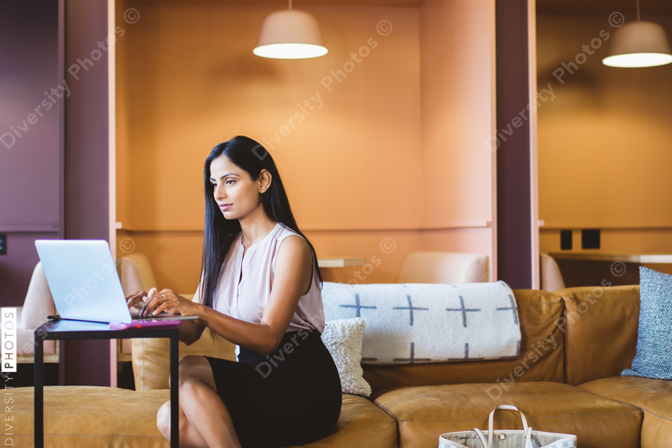 Young businesswoman working on laptop in office