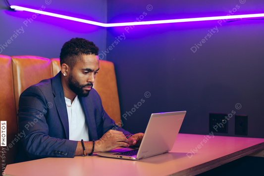 Young businessman working on laptop while sitting in office