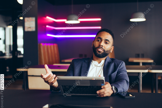 Young businessman working while sitting in office