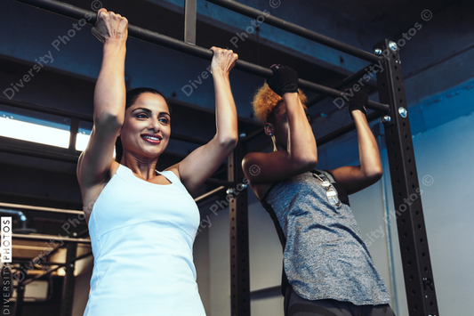 Young friends working out in gym