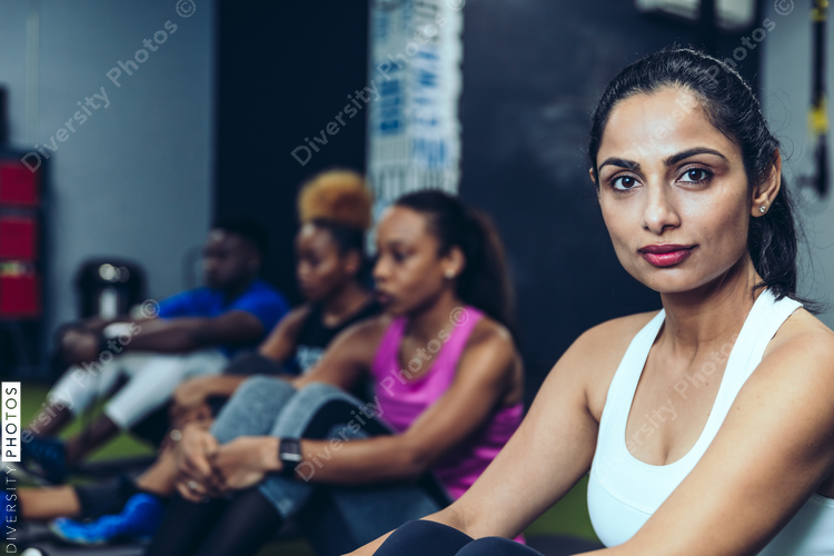 Portrait of young woman sitting in gym