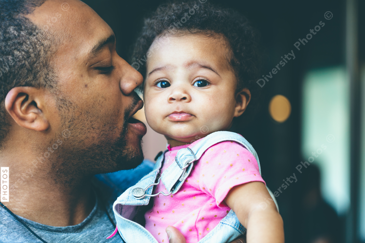 Father holding baby daughter