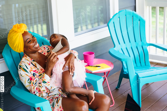 Beautiful mother and daughter sitting on front porch