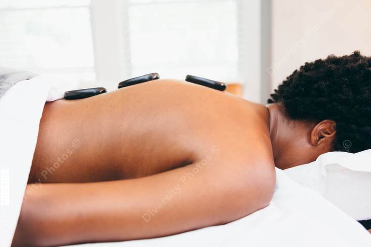 Black woman getting relaxing massage from black masseuse