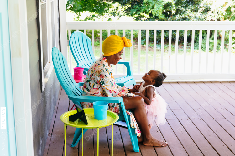 Mother and daughter playing on front porch