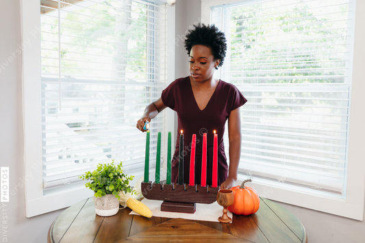Black mother lighting kwanza candles 