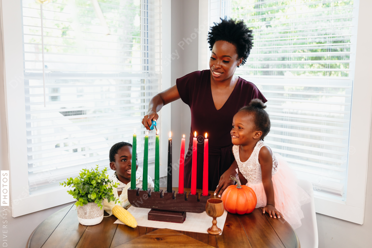 Black mother lighting kwanza candles 