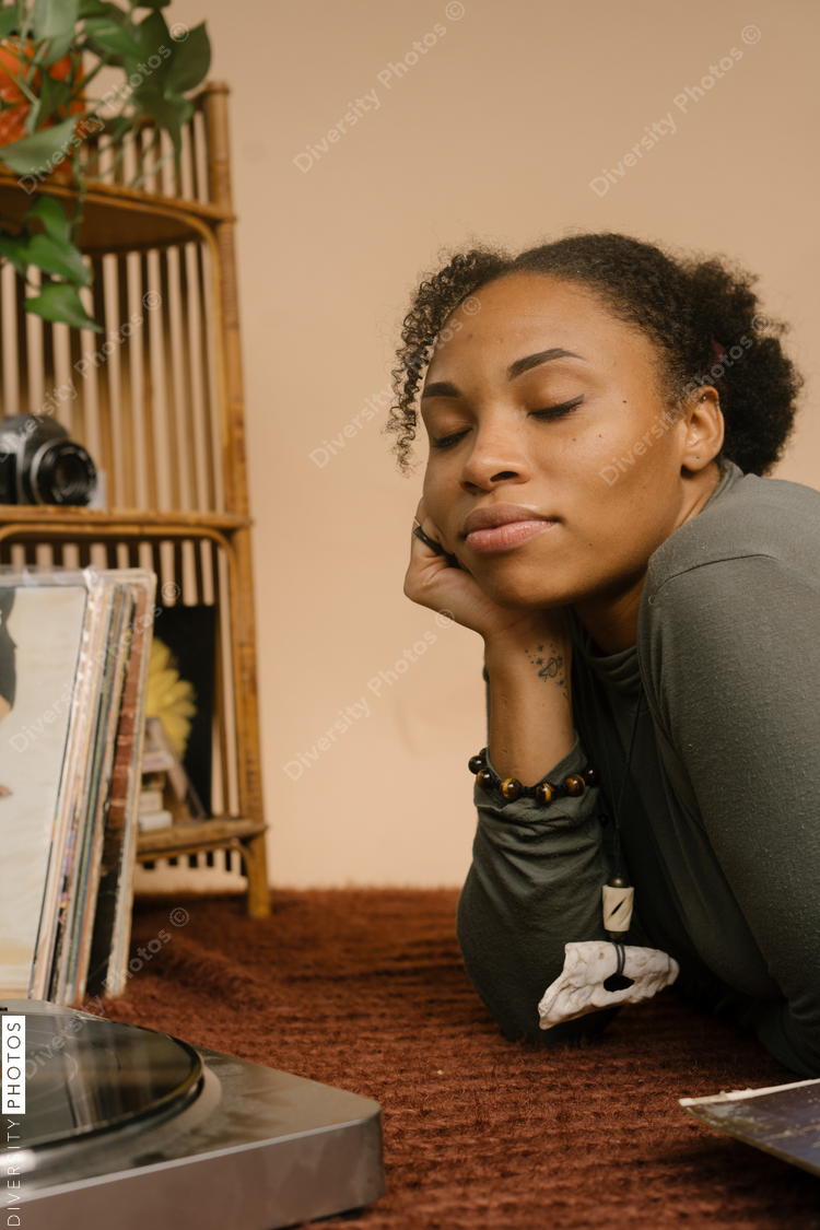 Black woman listening to vintage vinyl records music