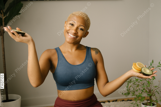 Young healthy woman holding fruit slices