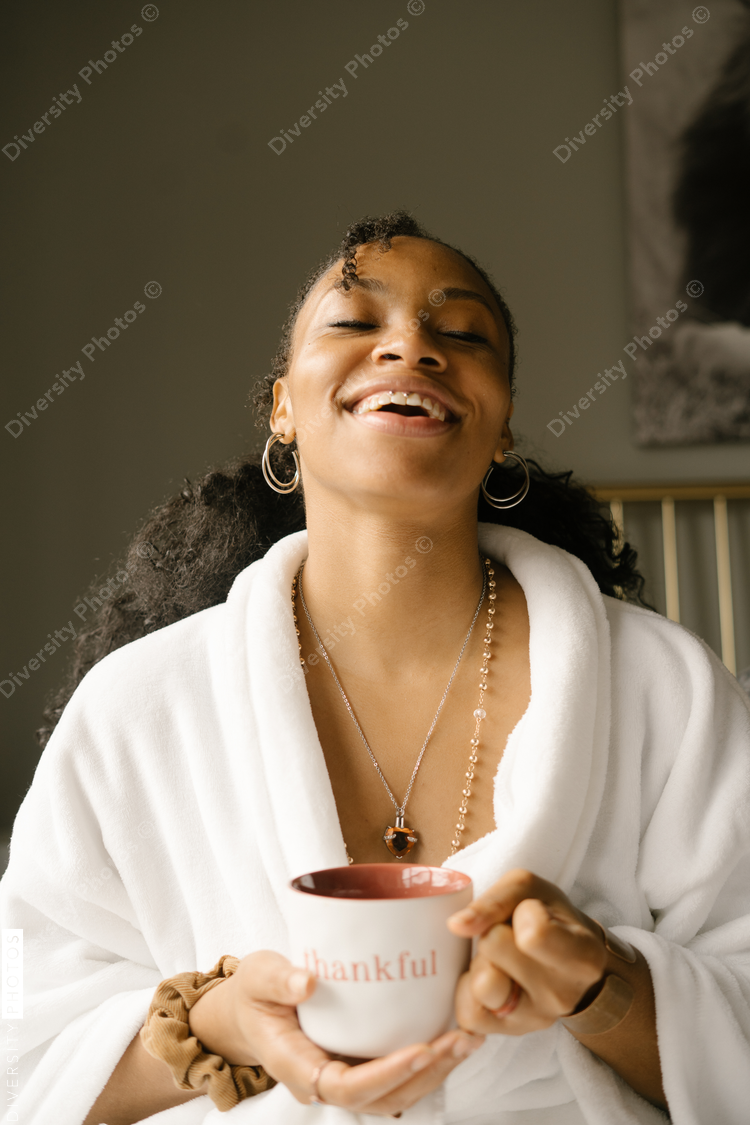 Woman drinking coffee at home in bed
