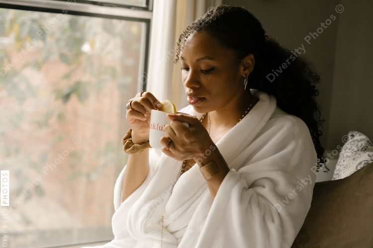 Woman drinking coffee at home in bed