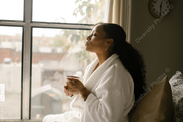 Woman drinking coffee at home in bed