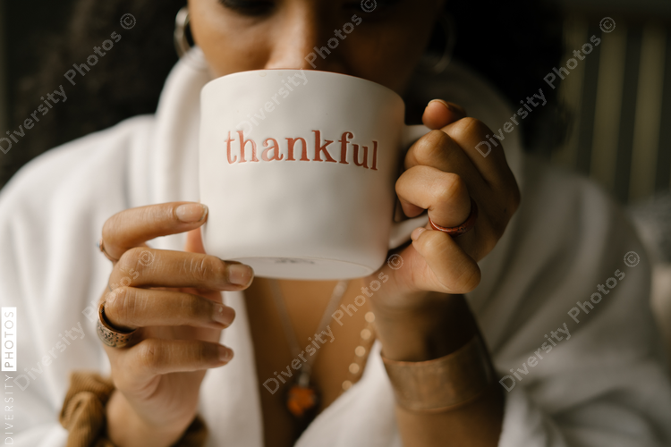 Woman drinking coffee at home in bed