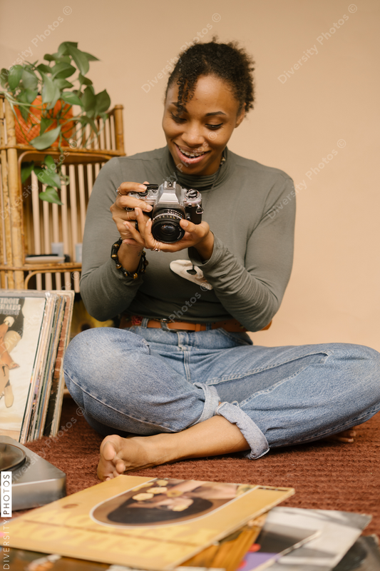 Black female photographer using vintage camera