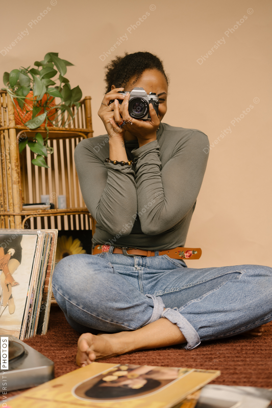 Black female photographer using vintage camera