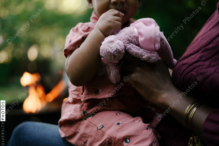 Mother and daughter outdoors sitting next to firepit at home
