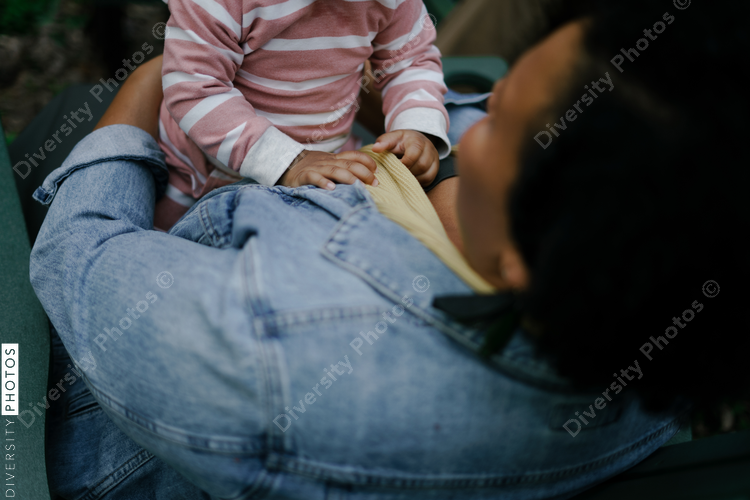 Mother and daughter outdoors sitting next to firepit at home