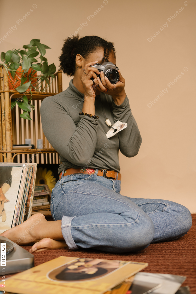 Black female photographer using vintage camera