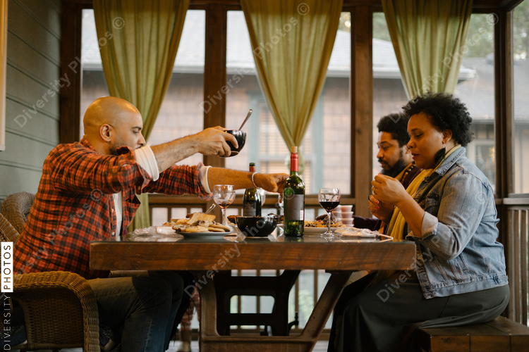 Black friends eating dinner together for date night get together