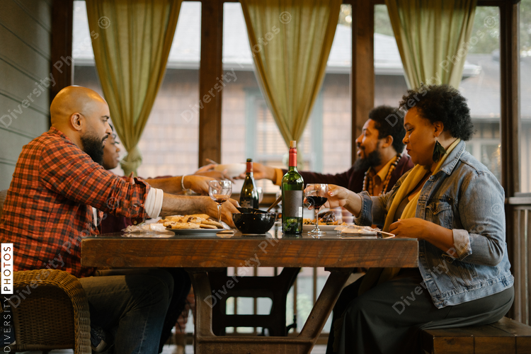 Black friends eating dinner together for date night get together